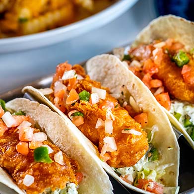 3 beer-battered cod tacos with shredded lettuce, and pico de gallo